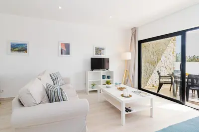 a living room with a white couch and a table at Villa Infante in Sagres