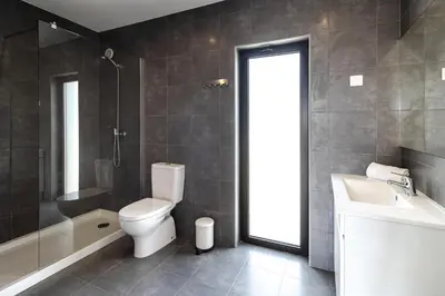 a bathroom with a toilet and a tub and a sink at Villa Infante in Sagres