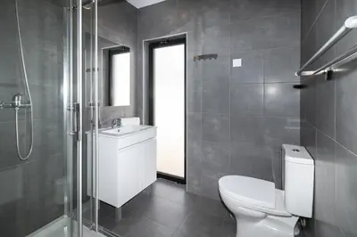 a bathroom with a toilet and a sink and a shower at Villa Infante in Sagres