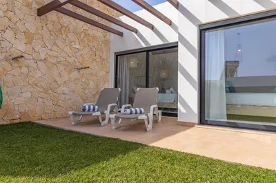 a patio with two chairs and a table at Villa Infante in Sagres