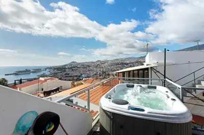 a kitchen with white cabinets and a white dishwasher at Sissi Lanço View 7 in Funchal