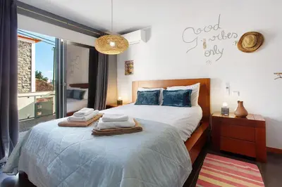 a bedroom with a large bed with towels on it at Sissi Lanço View 7 in Funchal