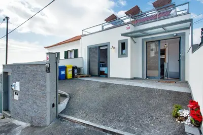 a white house with a garage and a driveway at Sissi Lanço View 7 in Funchal