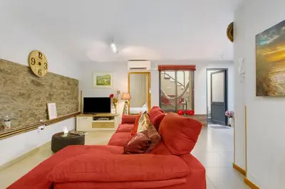 a living room with a red couch and a tv at Sissi Lanço View 7 in Funchal