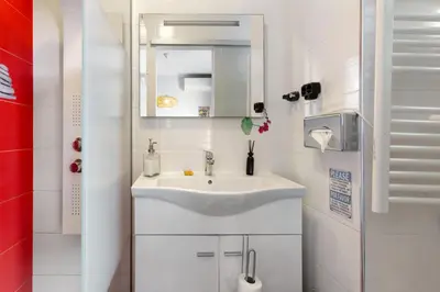 a white bathroom with a sink and a mirror at Sissi Lanço View 7 in Funchal