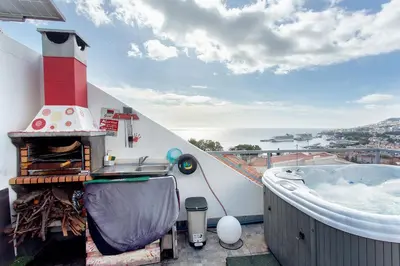 a balcony with a hot tub and a lighthouse at Sissi Lanço View 7 in Funchal