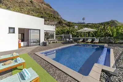 a villa with a swimming pool and a house at Villa Graycis House by Villa Plus in Arco da Calheta