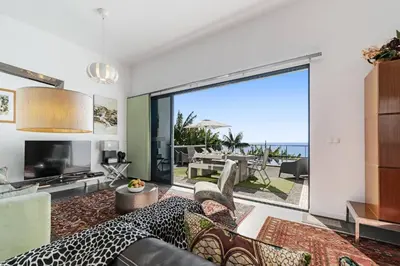 a living room with a view of the ocean at Villa Graycis House by Villa Plus in Arco da Calheta
