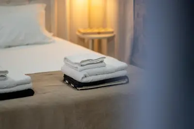a pile of towels sitting on top of a bed at Calma Retreat - Pool & Lodge in Câmara de Lobos