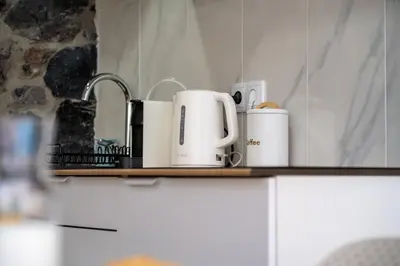 a shelf with three coffee cups on it at Calma Retreat - Pool & Lodge in Câmara de Lobos