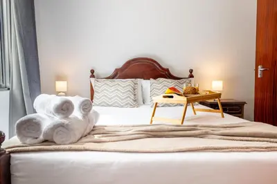 a bedroom with a bed with towels on it at Solar do Pico Apartment in Ponta Delgada