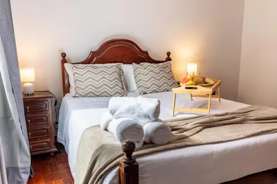 a bedroom with a bed with towels on it at Solar do Pico Apartment in Ponta Delgada