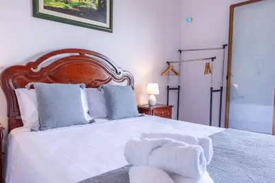 a bedroom with a white teddy bear sitting on a bed at Solar do Pico Studio in Ponta Delgada