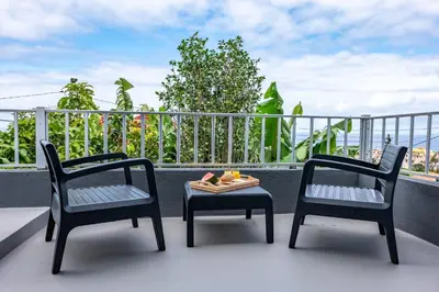 two chairs and a table on a balcony at Solar do Pico Studio in Ponta Delgada