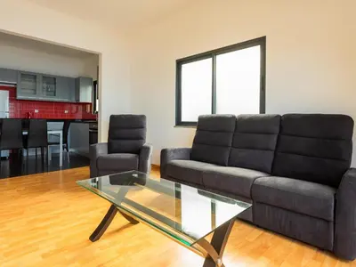 a living room with a couch and a glass table at Skyline Villas RC in Arco da Calheta