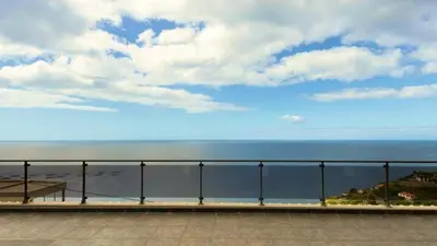 an external view of a house with a garage at Skyline Villas Top in Arco da Calheta