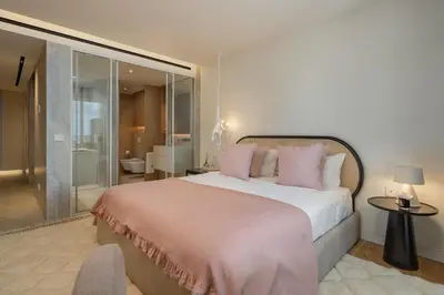 a bedroom with a large bed with pink pillows at Savoy Monumentalis VIII by An Island Apart in Funchal