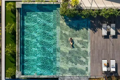 an overhead view of a swimming pool with a person in the water at Savoy Monumentalis VIII by An Island Apart in Funchal
