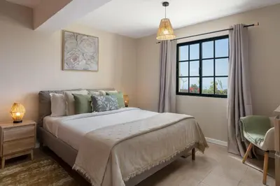 a bedroom with a large bed and a window at Relax Garden House by An Island Apart in Arco da Calheta