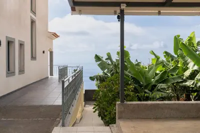 a balcony with a view of the ocean at Relax Garden House by An Island Apart in Arco da Calheta
