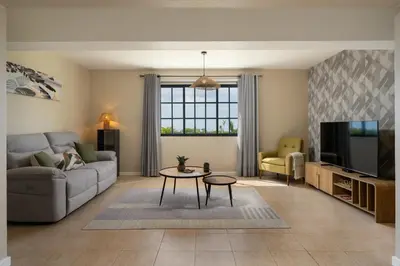 a living room with a couch and a tv at Relax Garden House by An Island Apart in Arco da Calheta