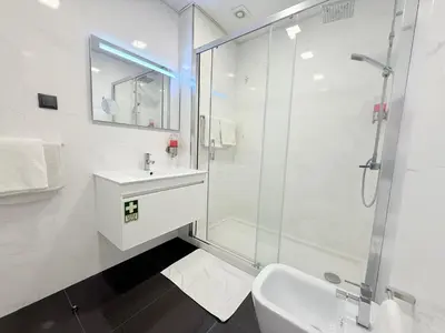 a white bathroom with a sink and a shower at Gold Center Funchal 102 in Funchal
