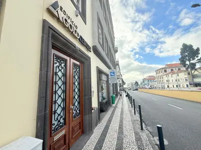 a building with a door on the side of a street at Gold Center Funchal 102 in Funchal