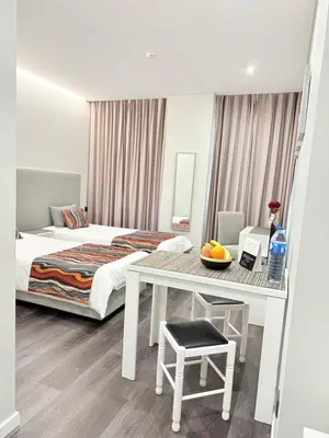 a bedroom with a bed and a table with a bowl of fruit at Gold Center Funchal 102 in Funchal