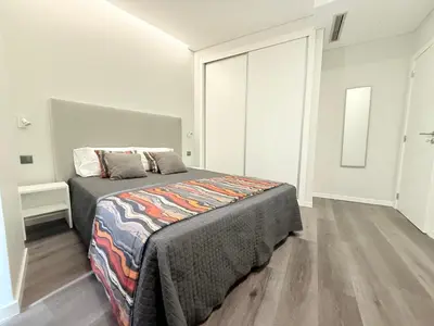 a bedroom with a bed in a white room at Gold Center Funchal 105 in Funchal