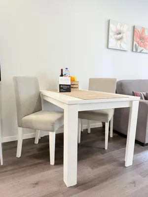 a white dining room table with two chairs and a box at Gold Center Funchal 105 in Funchal
