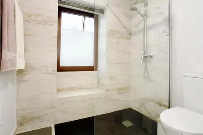 a white bathroom sink with a mirror above it at Tini´s House Madeira Holiday in Gaula