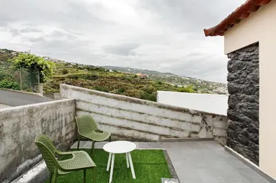a small house with two chairs and a table at Tini´s House Madeira Holiday in Gaula