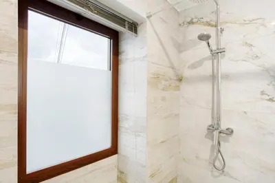 a shower in a bathroom with a window at Tini´s House Madeira Holiday in Gaula