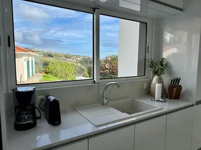 a kitchen counter with a sink and a window at Atlantic View in Arco da Calheta