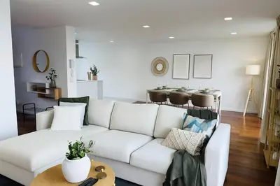 a living room with a white couch and a table at Atlantic View in Arco da Calheta