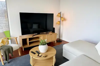 a living room with a tv and a couch and a table at Atlantic View in Arco da Calheta