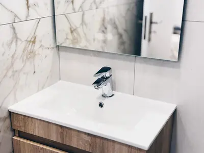 a bathroom with a sink and a mirror at A Casa Elena - Modern Family home in Praia da Luz in Luz