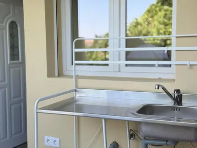 a kitchen with a sink and a window at A Casa Elena - Modern Family home in Praia da Luz in Luz