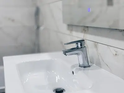 a white bathroom sink with a faucet on it at A Casa Elena - Modern Family home in Praia da Luz in Luz