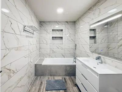 a white bathroom with a tub and a sink at A Casa Elena - Modern Family home in Praia da Luz in Luz