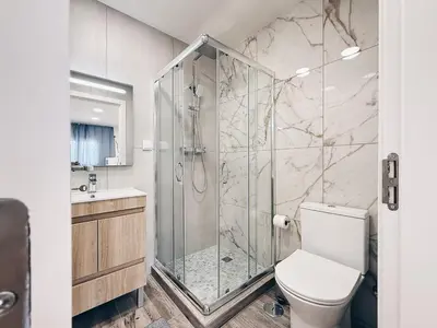 a bathroom with a shower and a toilet at A Casa Elena - Modern Family home in Praia da Luz in Luz