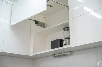 a kitchen with white cabinets with a appliance inside at Topaz Scape Garajau Madeira by GRM in Caniço