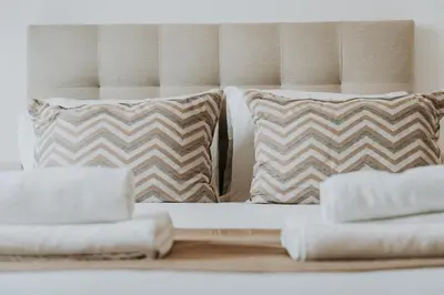 a bed with pillows on it with at Topaz Scape Garajau Madeira by GRM in Caniço