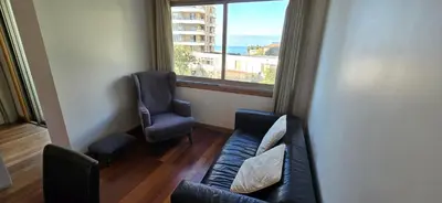 a living room with a couch and two chairs and a window at A Dream on the Cliff in Funchal