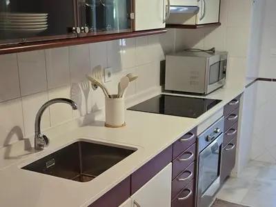 a kitchen with a sink and a microwave at A Dream on the Cliff in Funchal