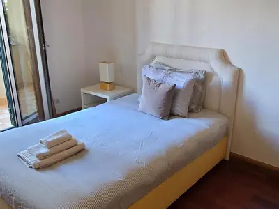 a bedroom with a white bed with towels on it at A Dream on the Cliff in Funchal