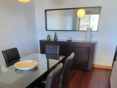 a dining room with a table and chairs and a mirror at A Dream on the Cliff in Funchal