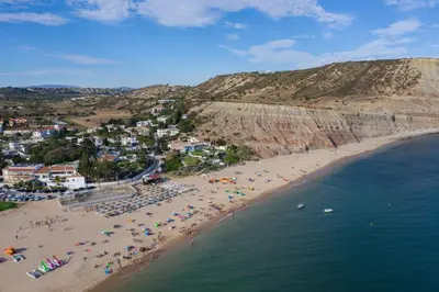an aerial view of a beach with people on it at Estúdio Praia da Luz in Luz