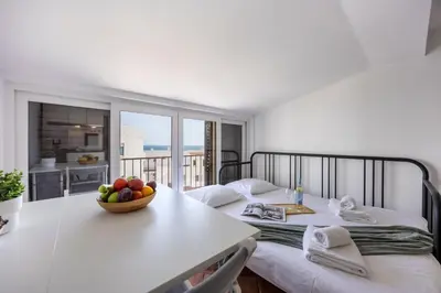 a room with a table with a bowl of fruit on it at Estúdio Praia da Luz in Luz