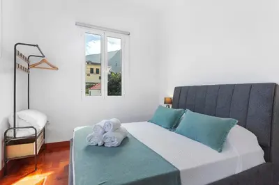 a bedroom with a bed with towels on it at Casa Da Avó Ferreirinha in Seixal